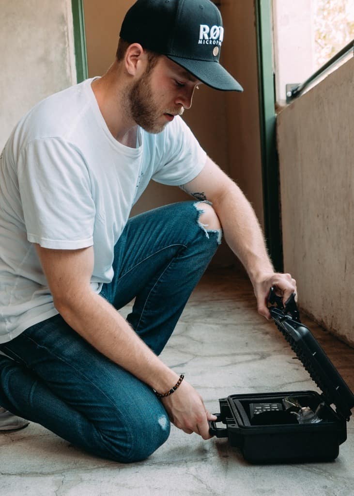 Man opening a gun safe on the floor