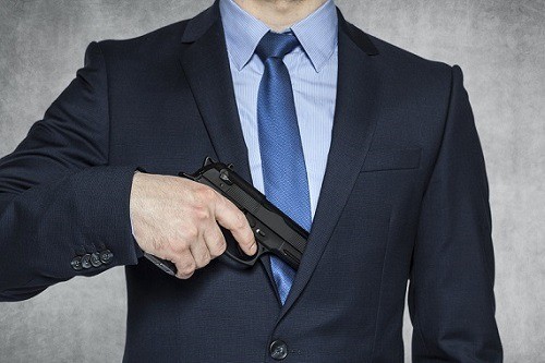 Man In Suit Holding Gun