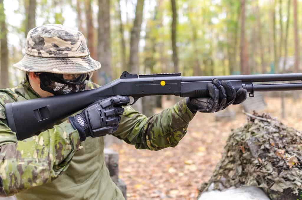 soldier in camouflage shooting hunting rifle