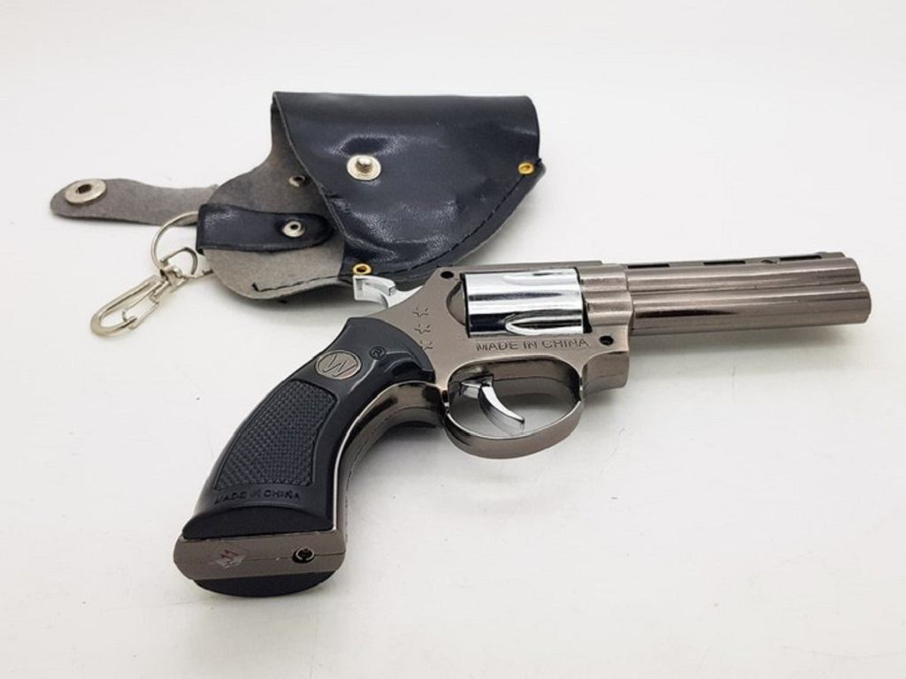 A revolver and a revolver holder on a white table