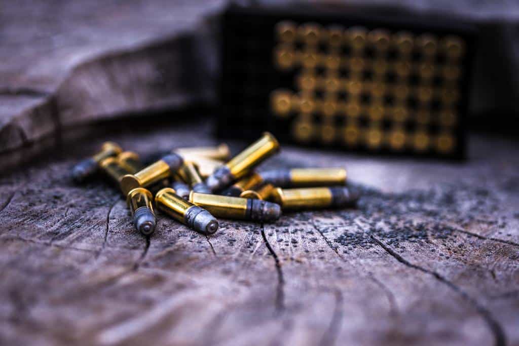 Pile of yellow steel cartridges on the wooden plank