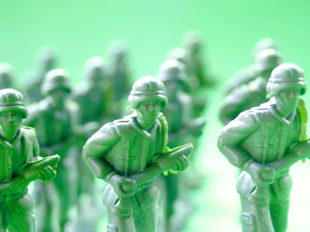 A group of green toy soldiers holding a gun