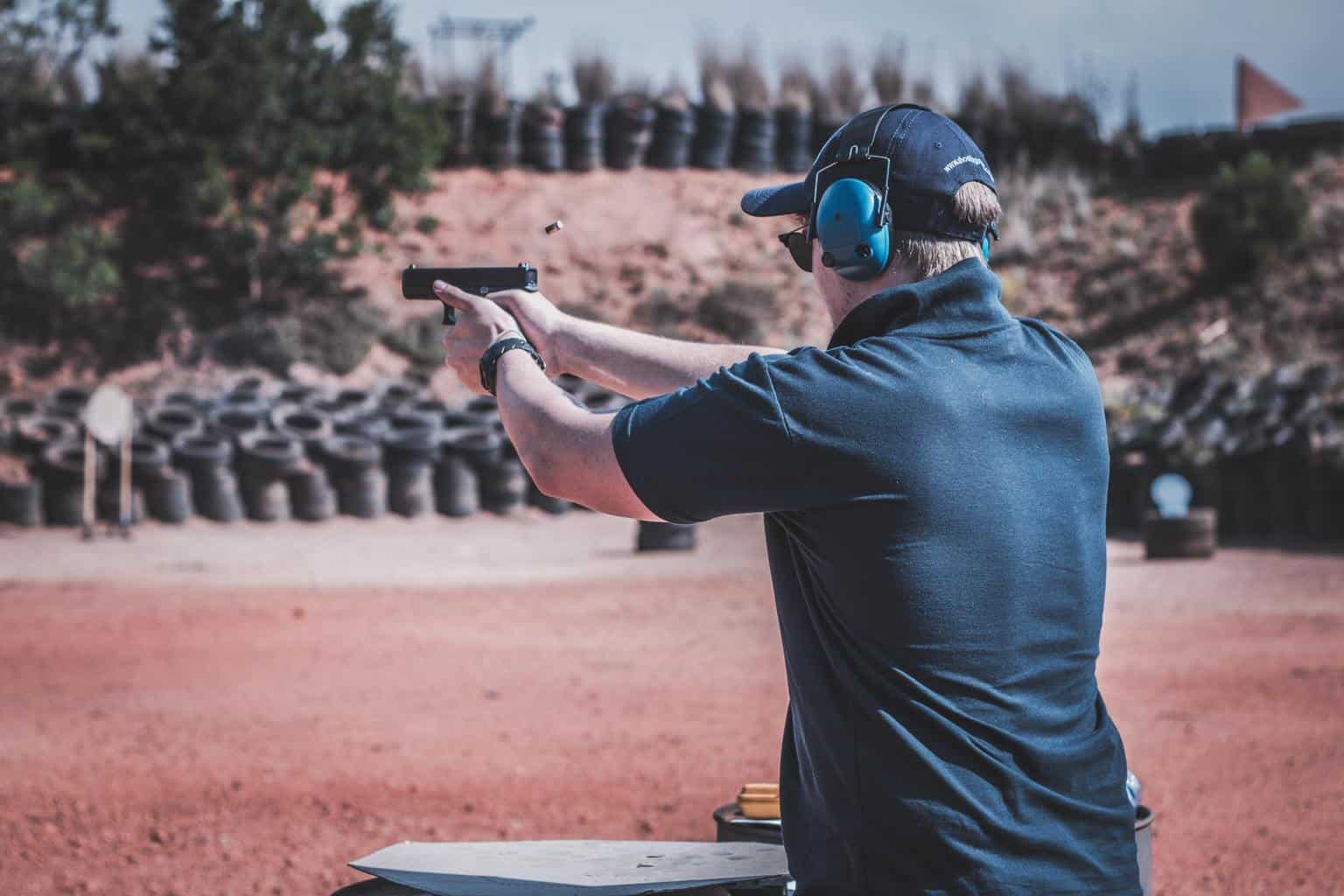 Man on a range holding a handgun