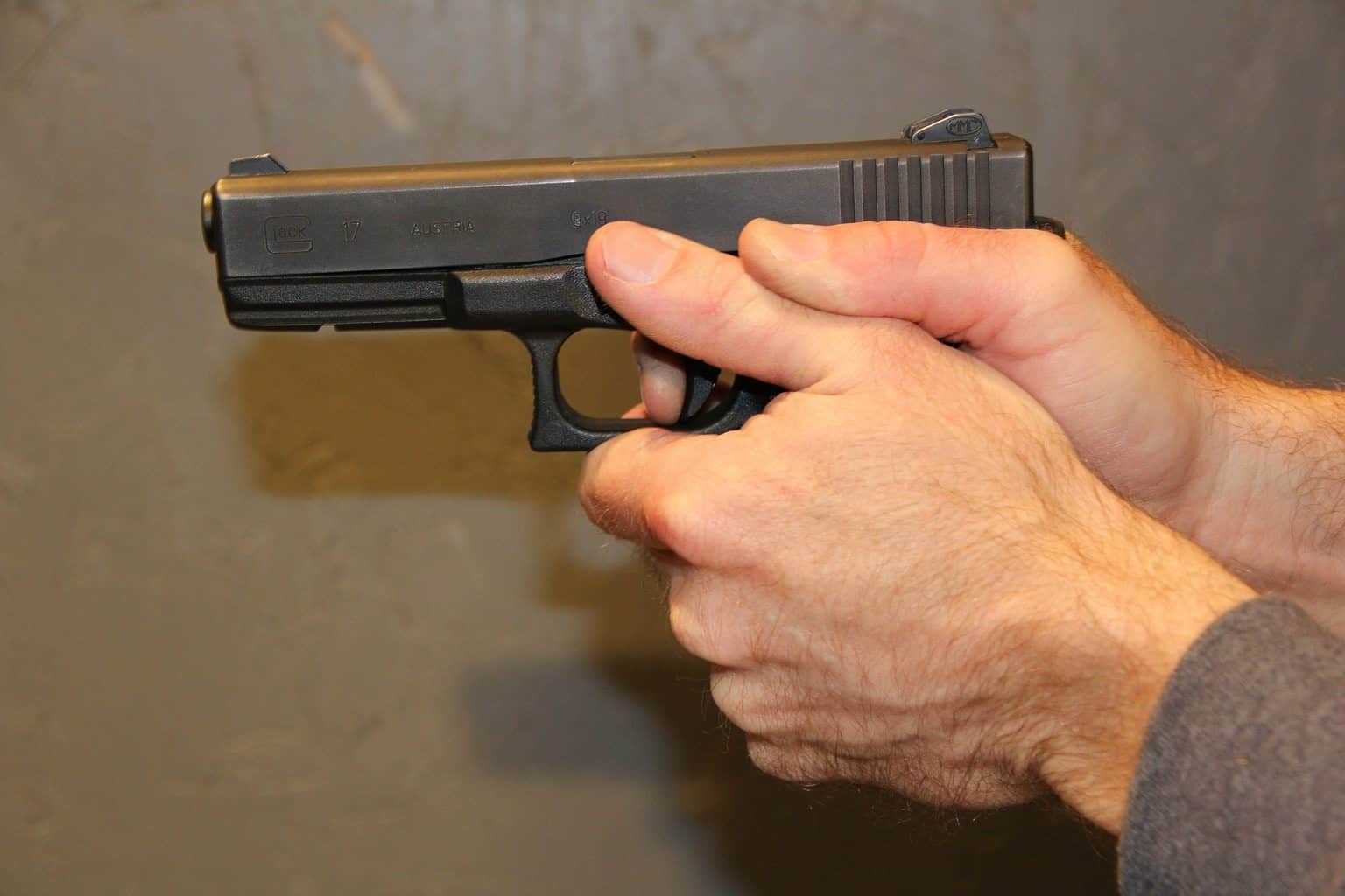 A person holding a handgun 