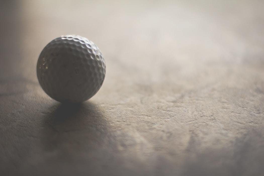 Golf ball on white surface