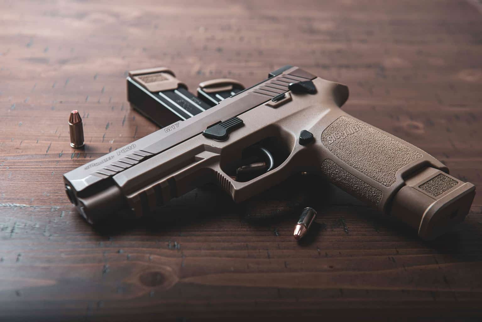 Brown-colored pistol on table