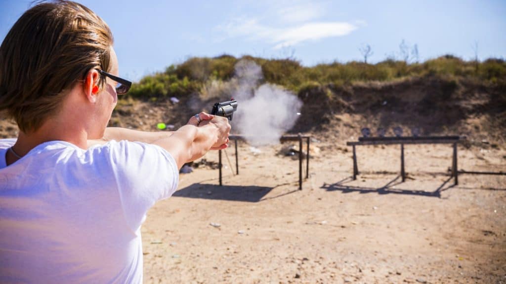 Woman target shooting in a gun range in the United States