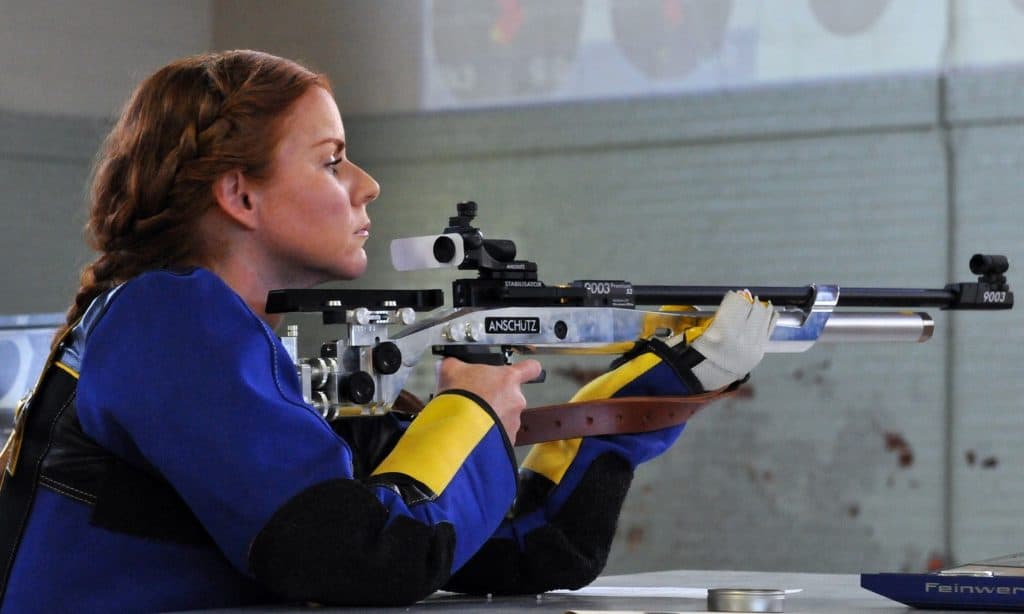 Woman holding a rifle at a gun range in Illinois