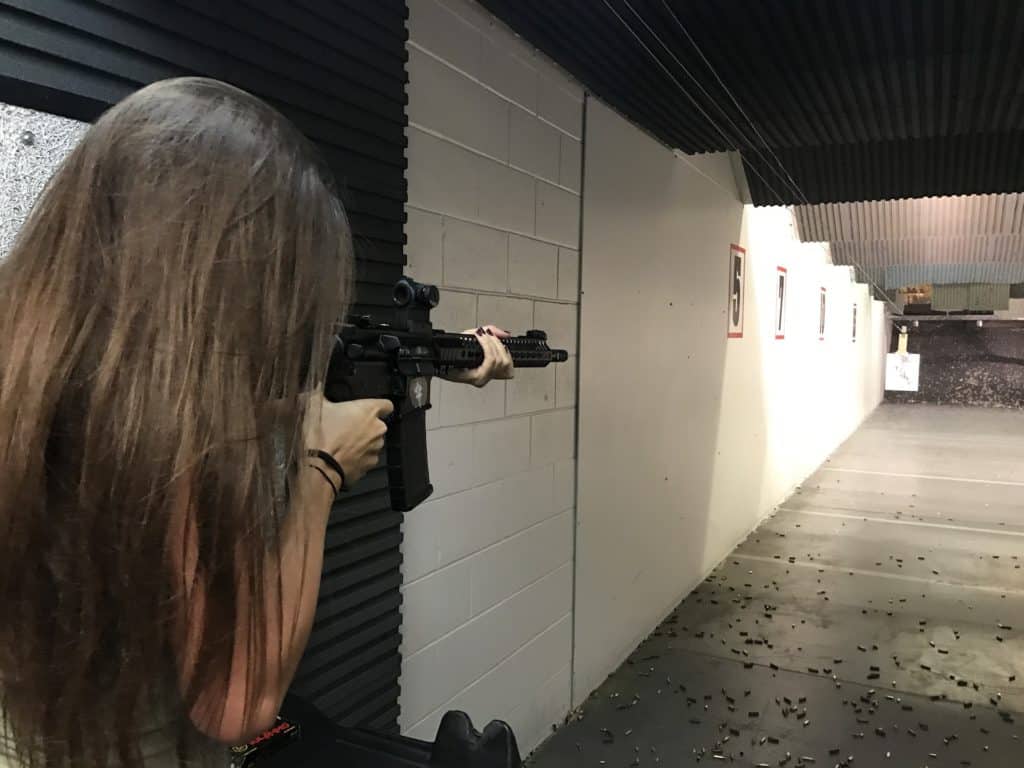 Woman aiming her rifle at a gun range in Maine