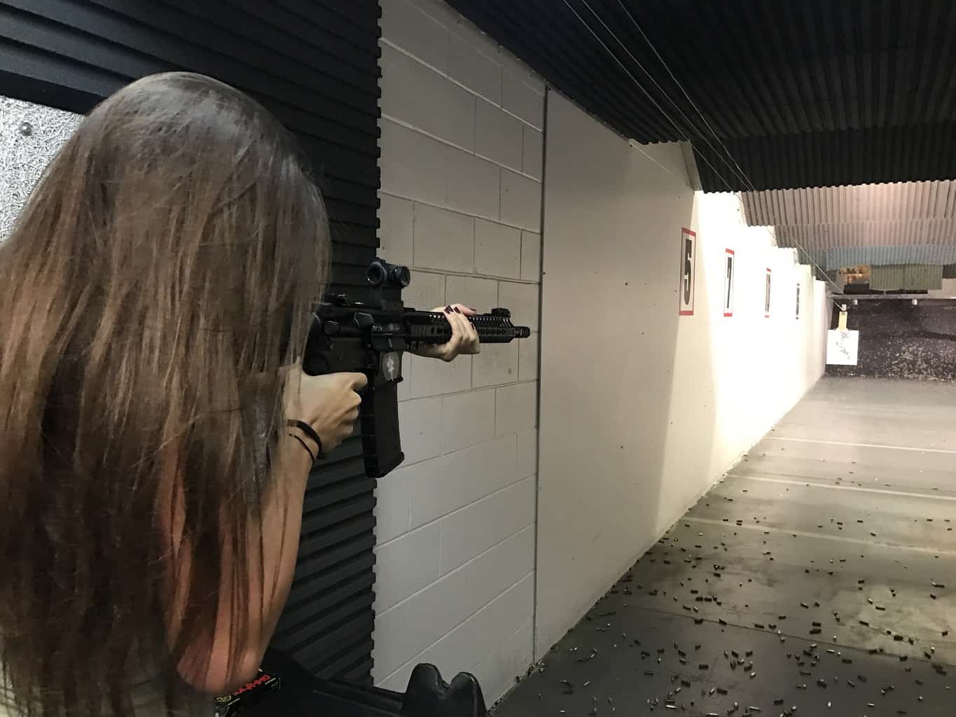Woman aiming her rifle at a gun range in Maine
