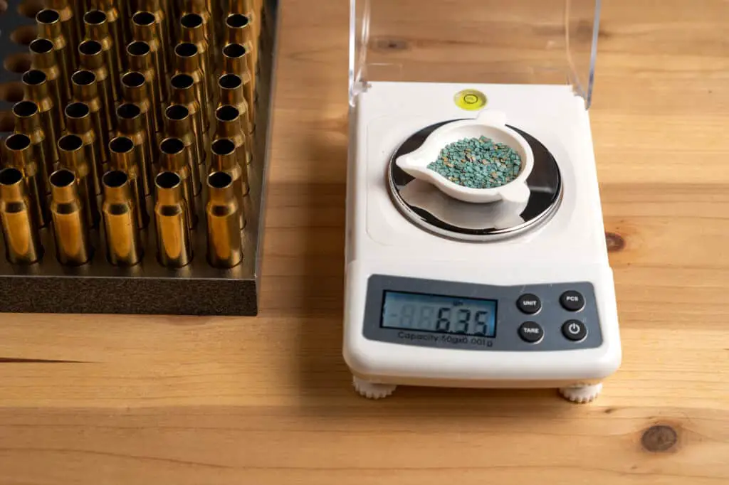 Gunpowder scales being weighed on a reloading scale
