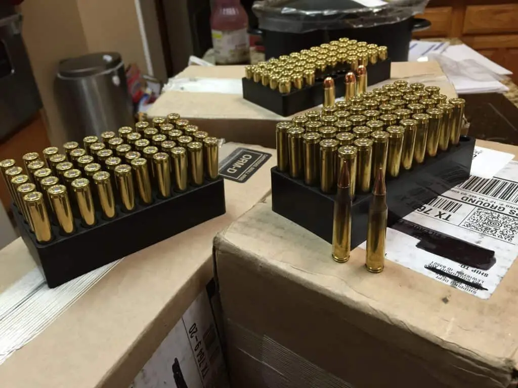 Three opened boxes of .233 bullets