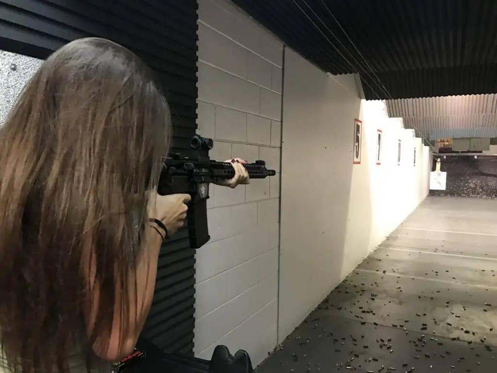 Woman firing a gun in a gun range