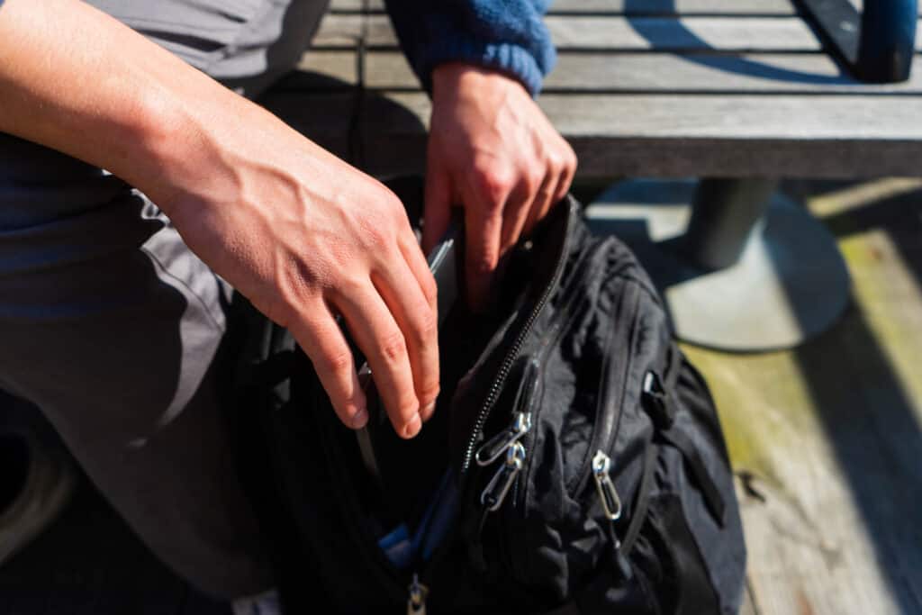 Person rifling through his backpack