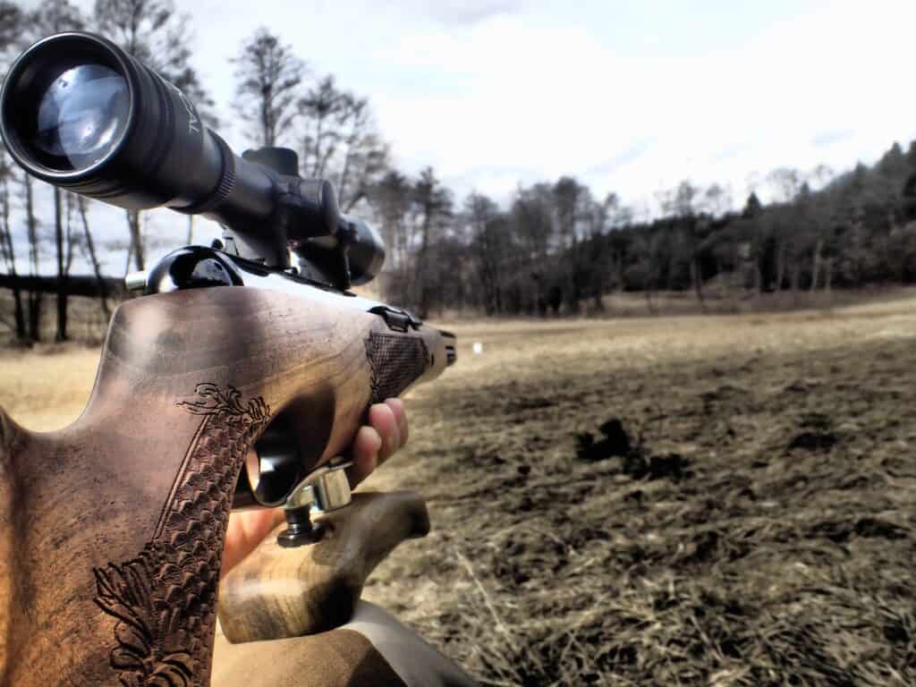Person aiming a gun at a distance at a gun range in Michigan