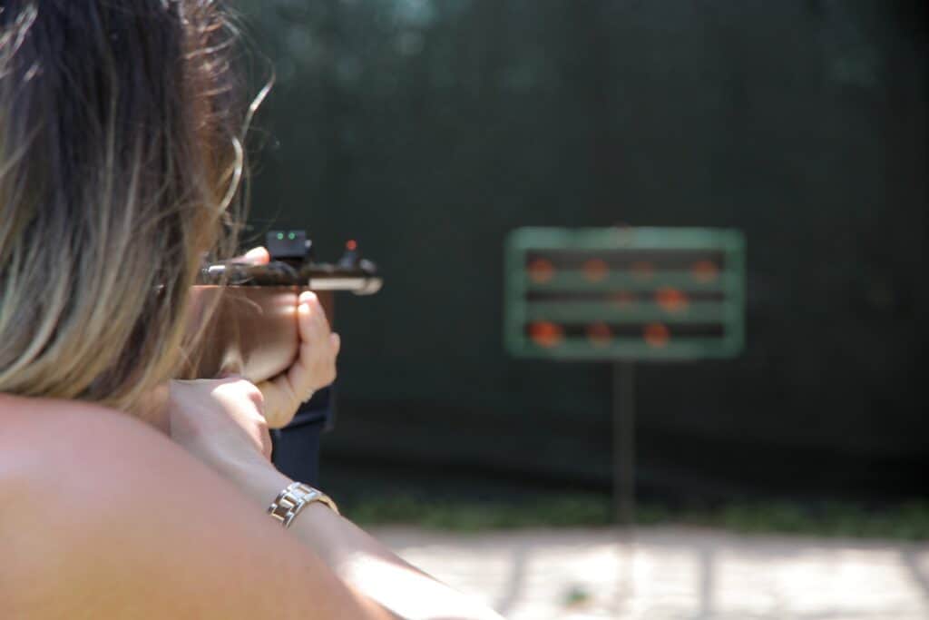 Woman aiming at a target