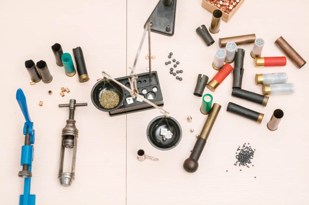 Shotgun cartridges reloading. capsules, shells, powder, cartridges, beam reloading scale on the table