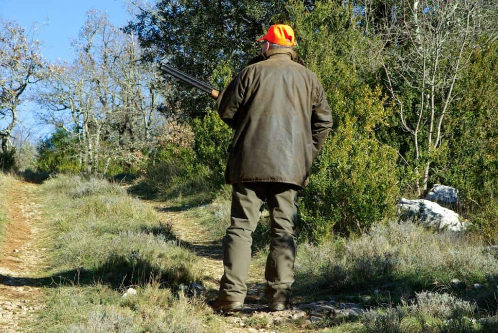 Man holding a rifle outdoors