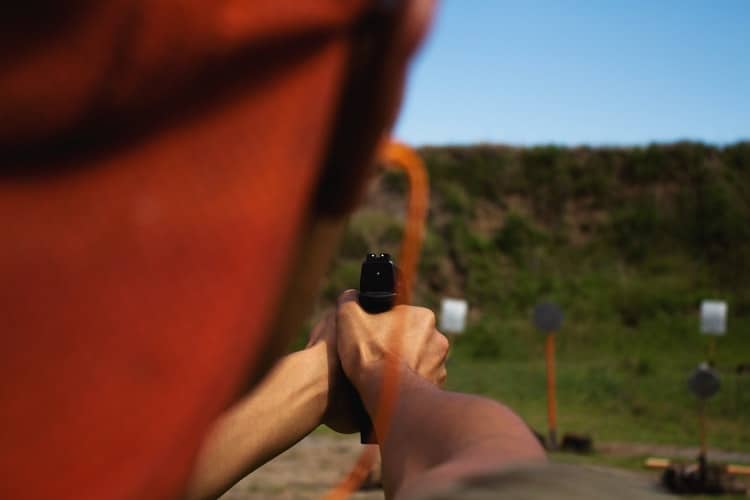 Person aiming at a target in a shooting range in Utah