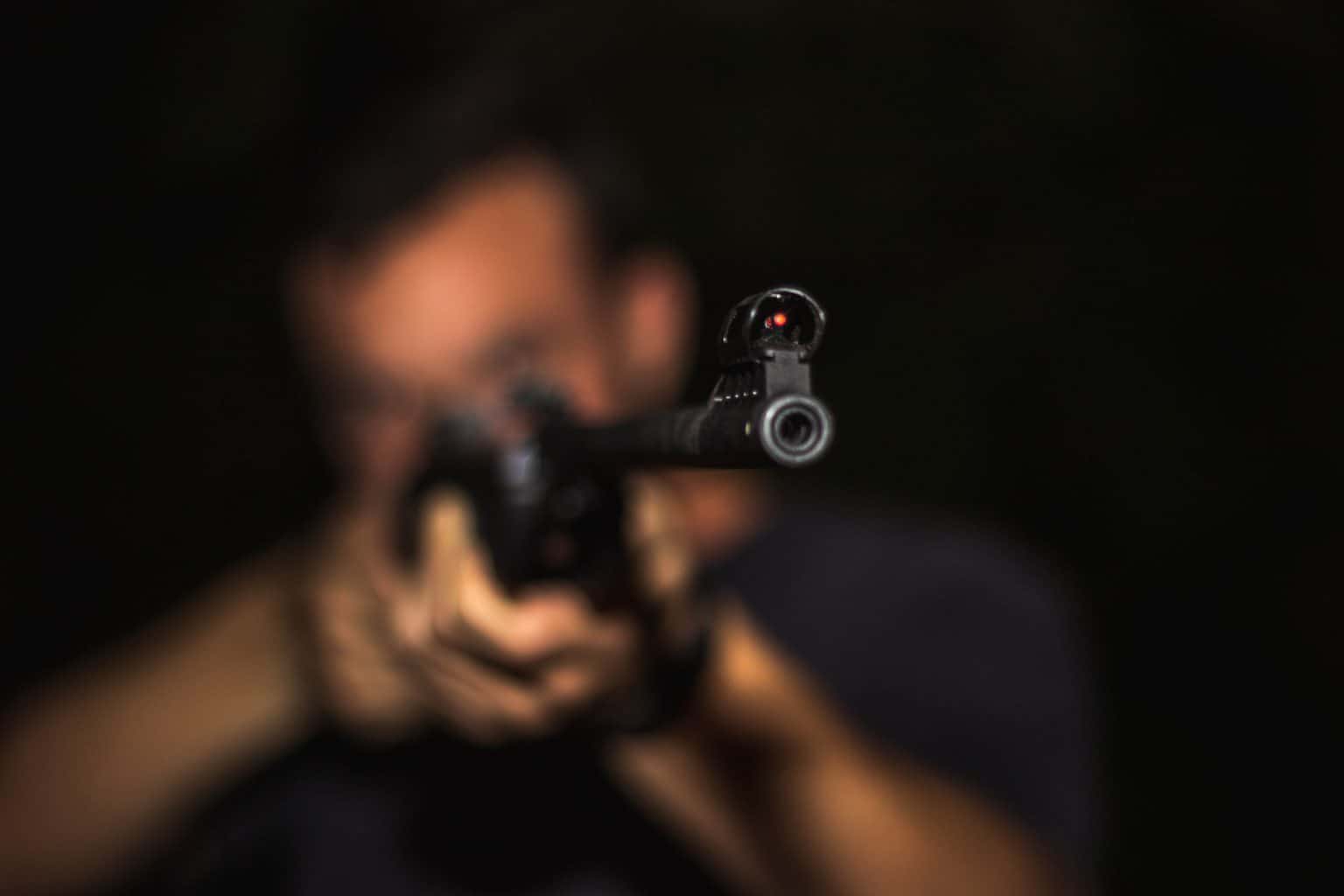 Man holding a shotgun at a shooting range in Colorado Springs