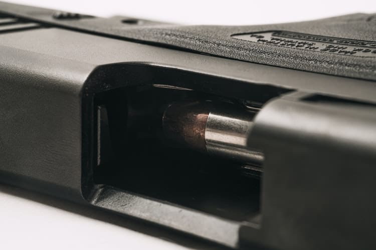 Close up of a bullet inside a gun