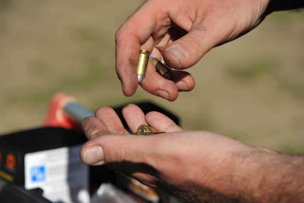 Man counting bullets in his hands