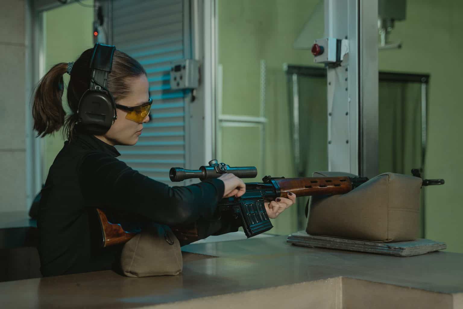 Woman reloading a rifle