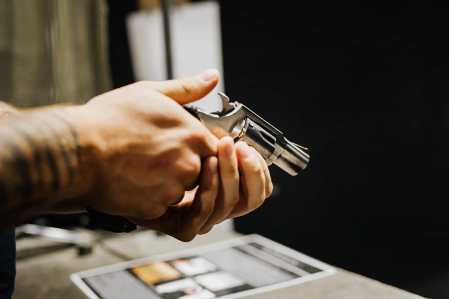 Man holding a gun wondering if he needs a gun permit to shoot at a gun range in Florida