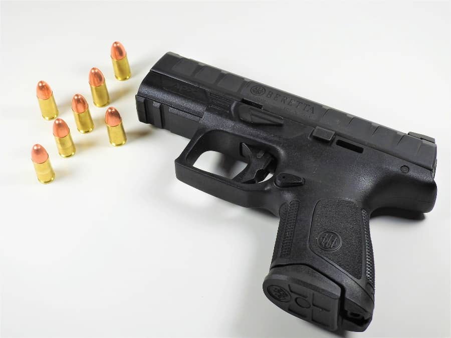 Handgun with bullets surrounding it