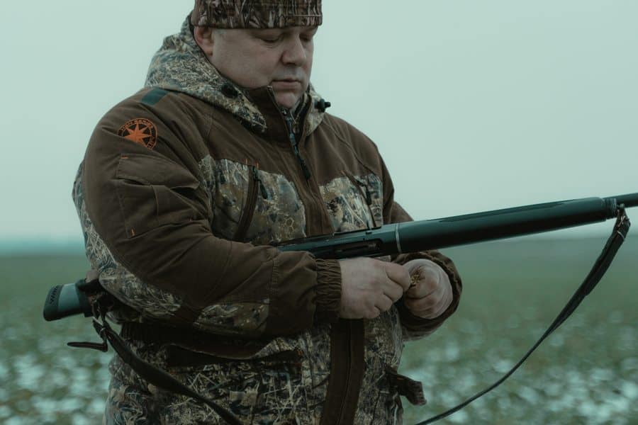 Man holding a gun wondering if he needs a gun permit to shoot at a gun range in Louisiana