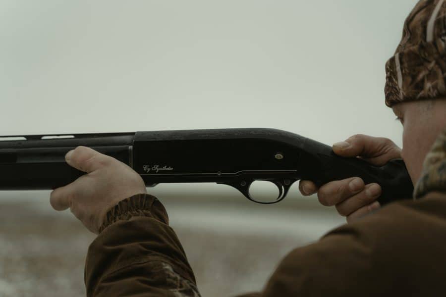 Man aiming his shotgun at a target