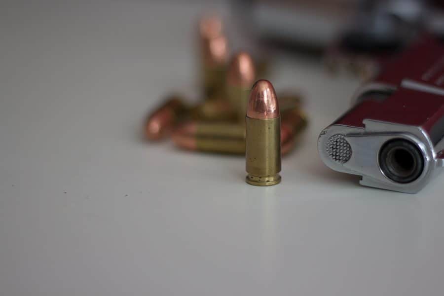 Bullets beside a handgun