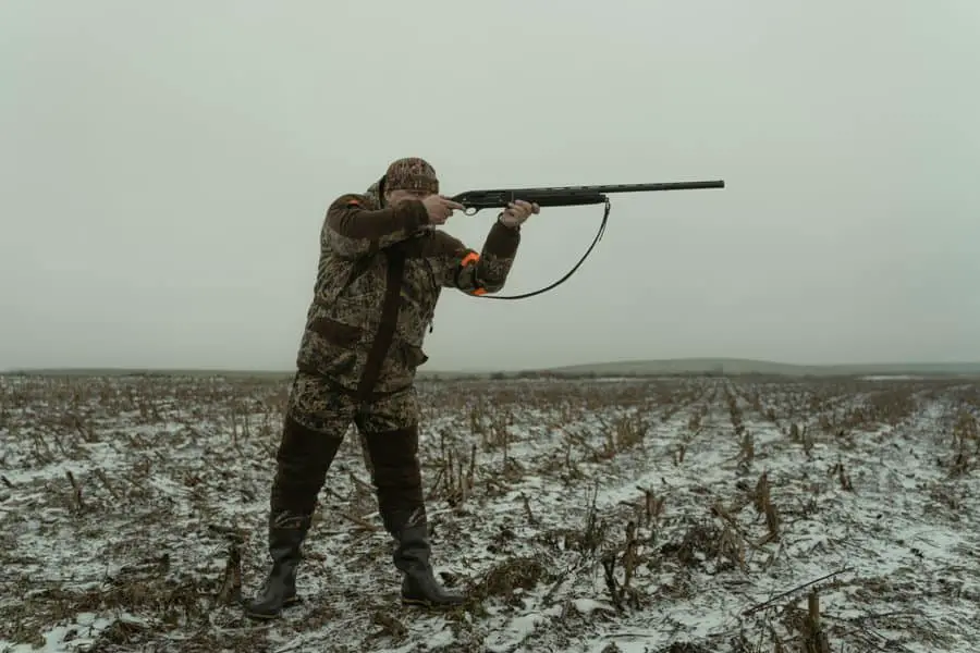 Man aiming to shoot, wondering if he needs a gun permit at a gun range in Massachusetts