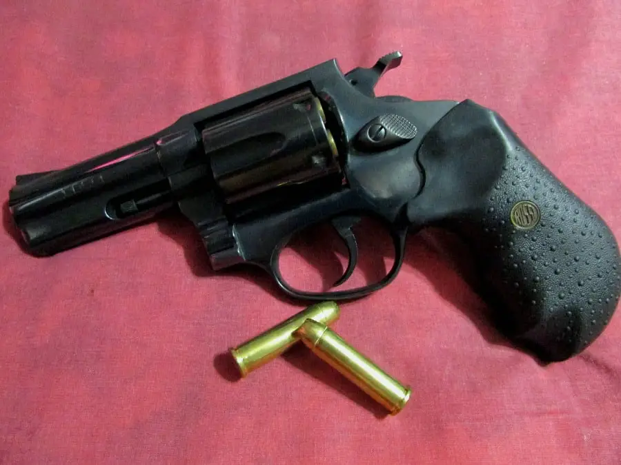 Handgun with bullets beside it