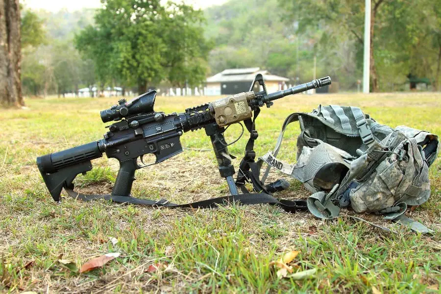 Rifle beside a range backpack