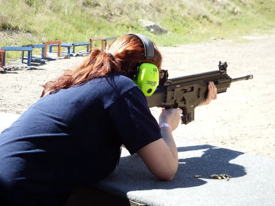 Woman aiming at a target and not needing a gun permit to shoot at a gun range in Oregon