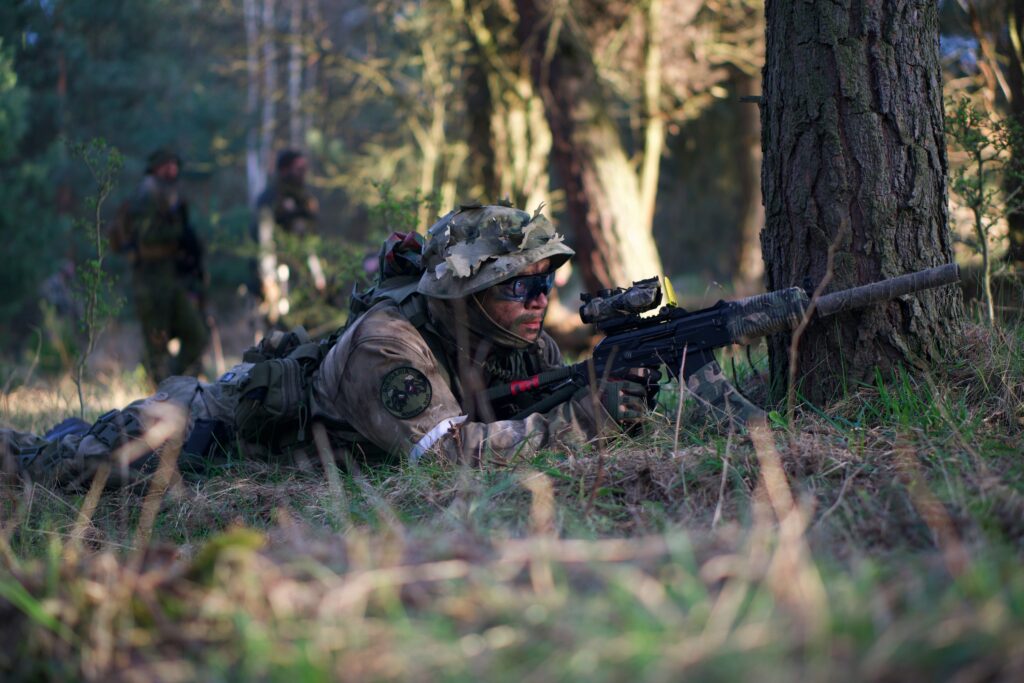 man aiming while lying down