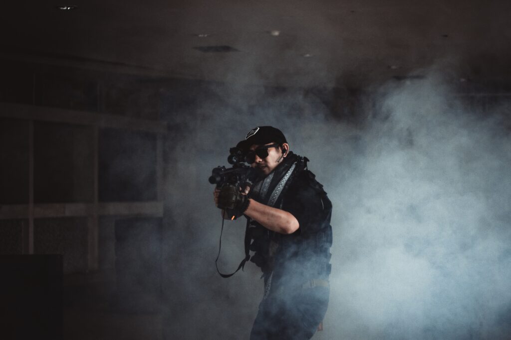 man aiming with a firearm in smoke