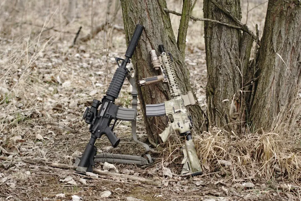 two rifles leaning to a tree trunk