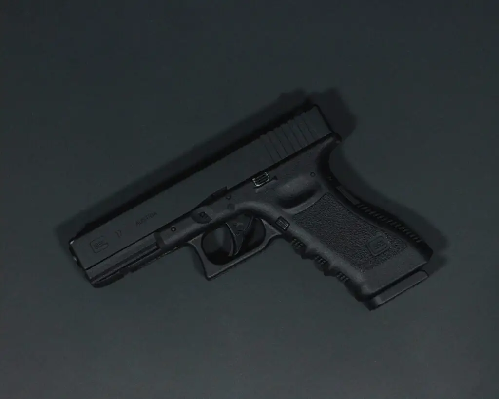 closeup shot of a handgun on a black table