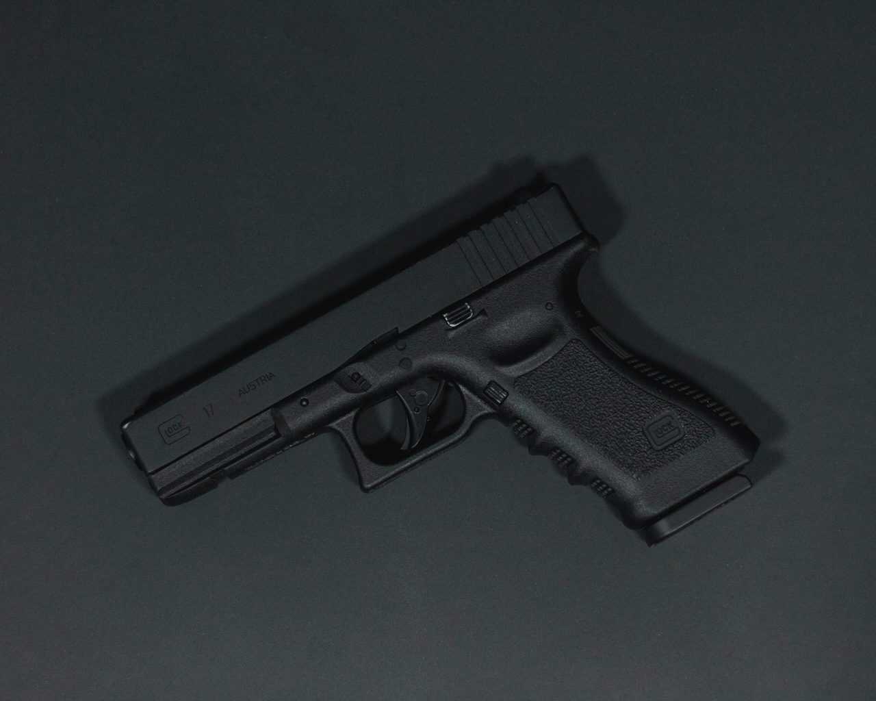 Closeup shot of a handgun on a black table