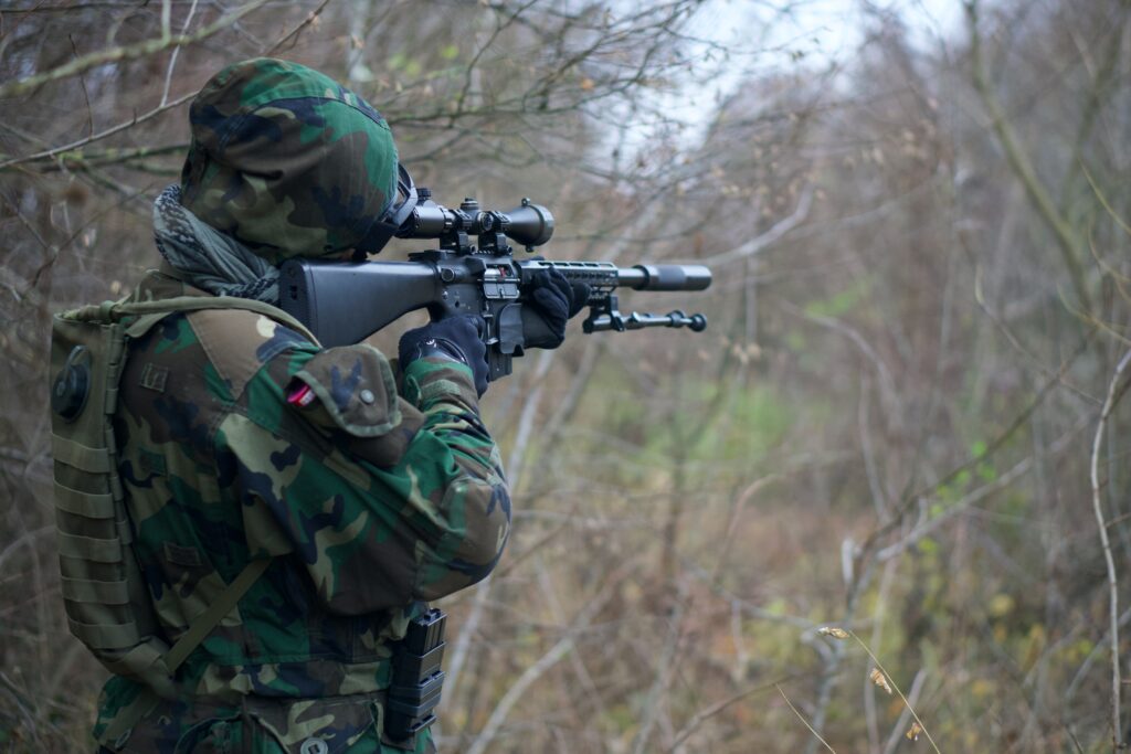 man aiming with scope