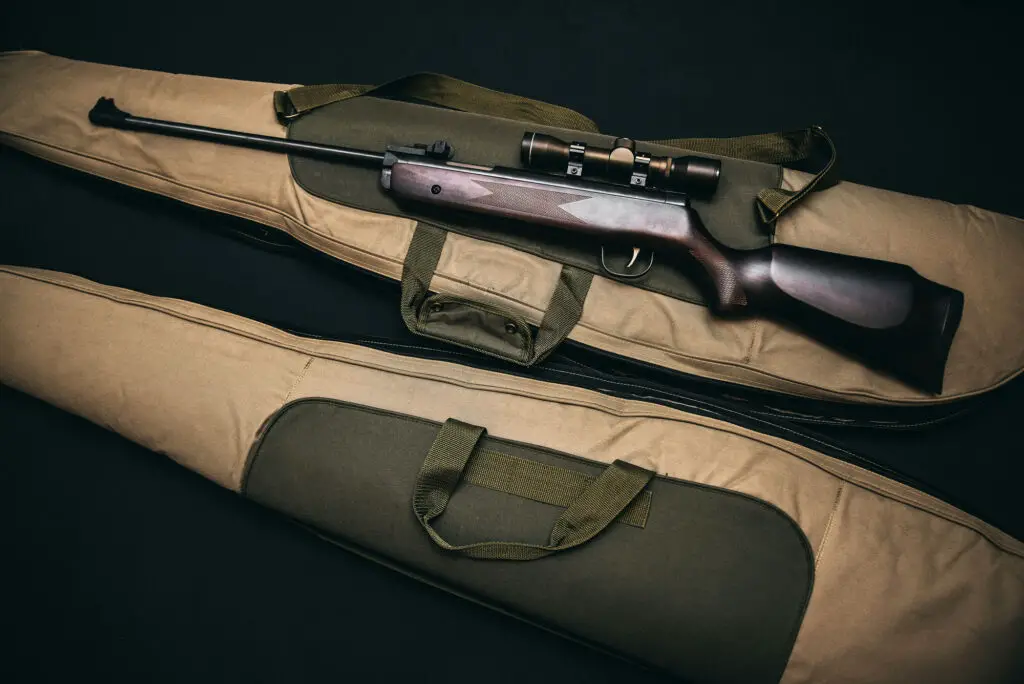 Brown rifle laid on top of firearm bag