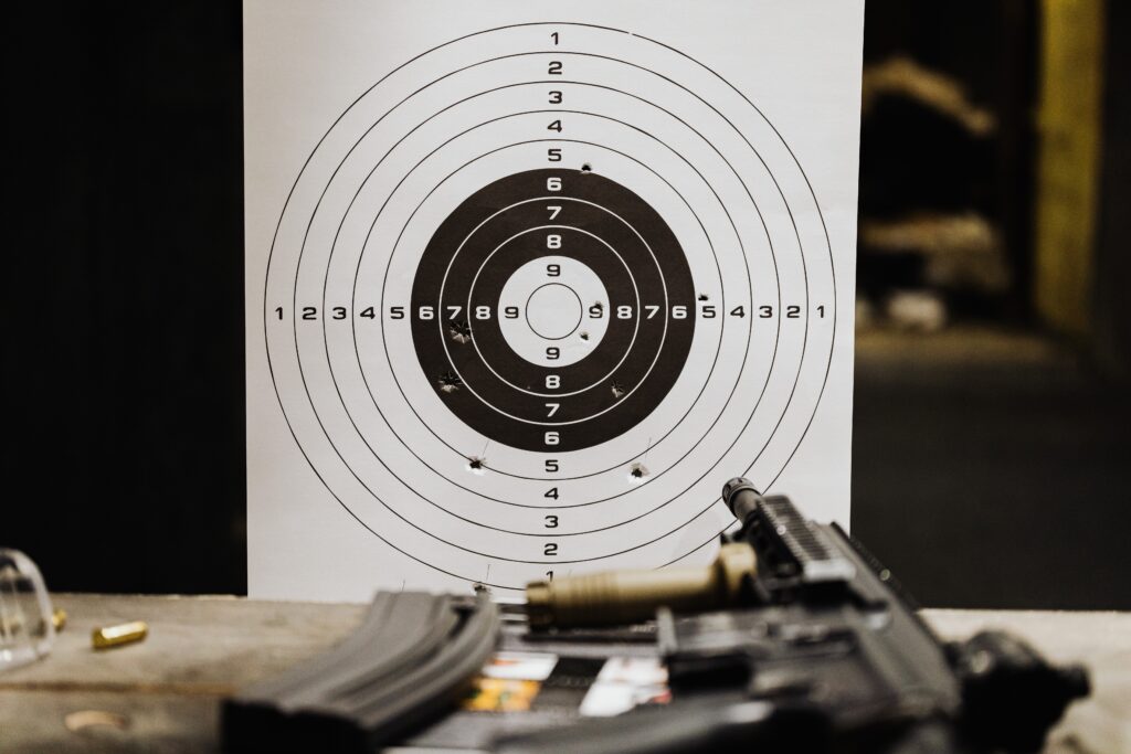 target paper and blurred shot of a gun and bullets