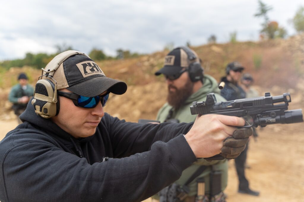 men practicing shooting outdoors