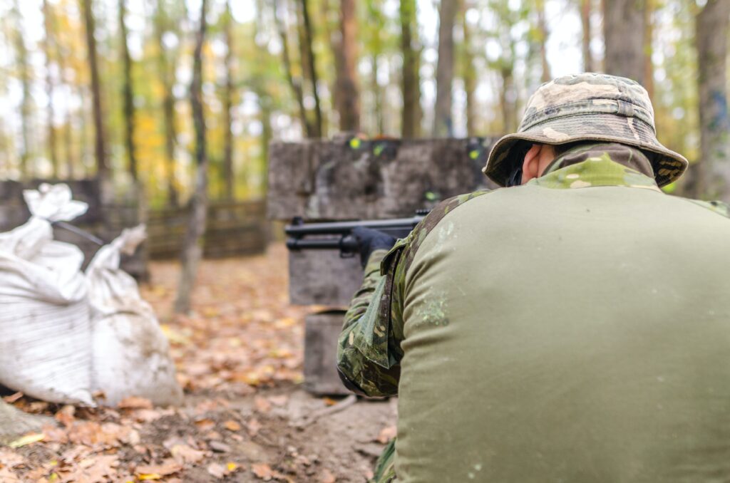 back shot of a man shooting a gun