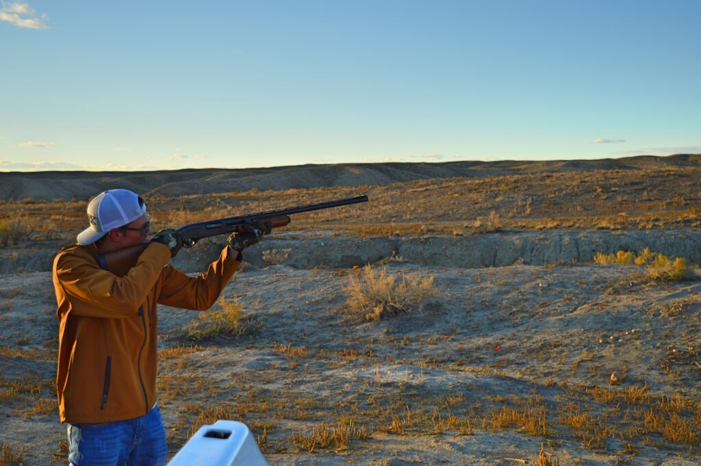 Man shooting gun in an open area