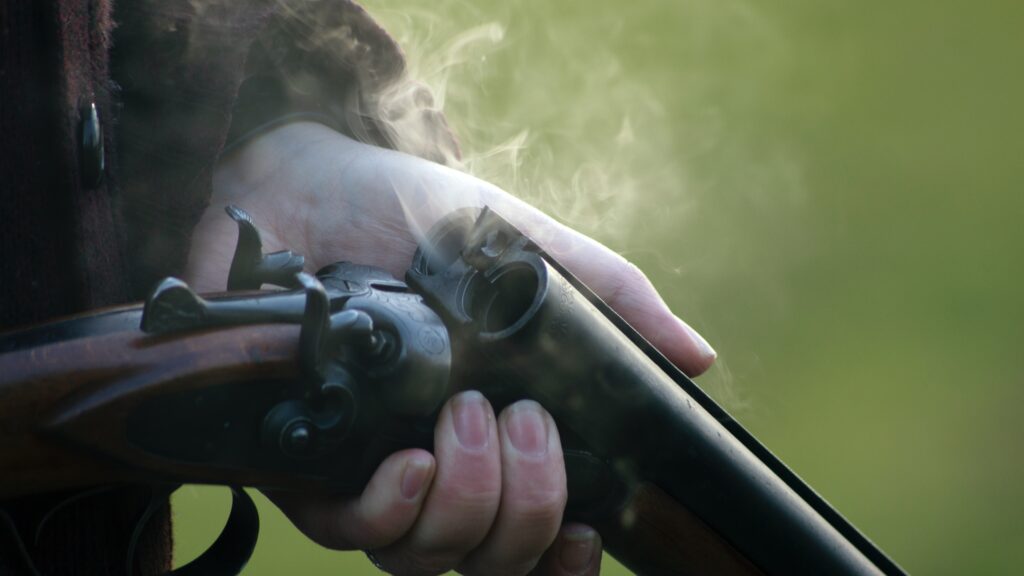 close up shot of shotgun with smoke