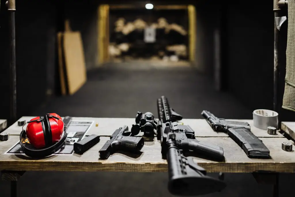 indoor shooting range with guns laid out infront