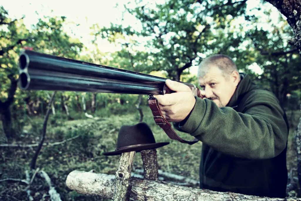 Man aiming rifle